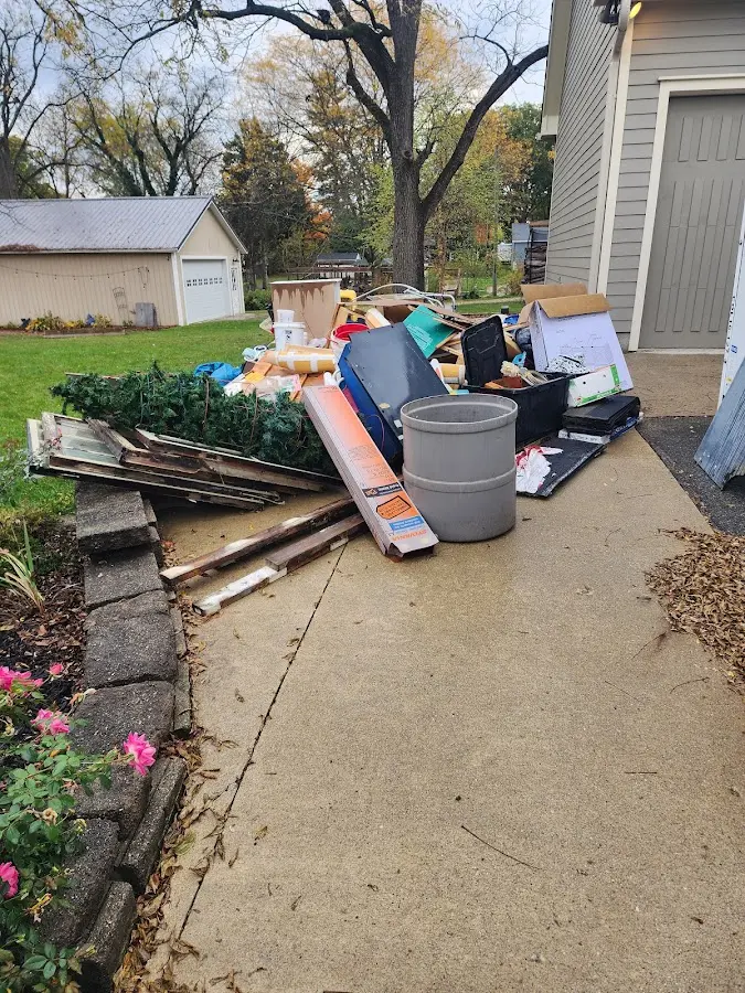 Dumpster being loaded with debris for Commercial Dumpster Rental in St. Clair